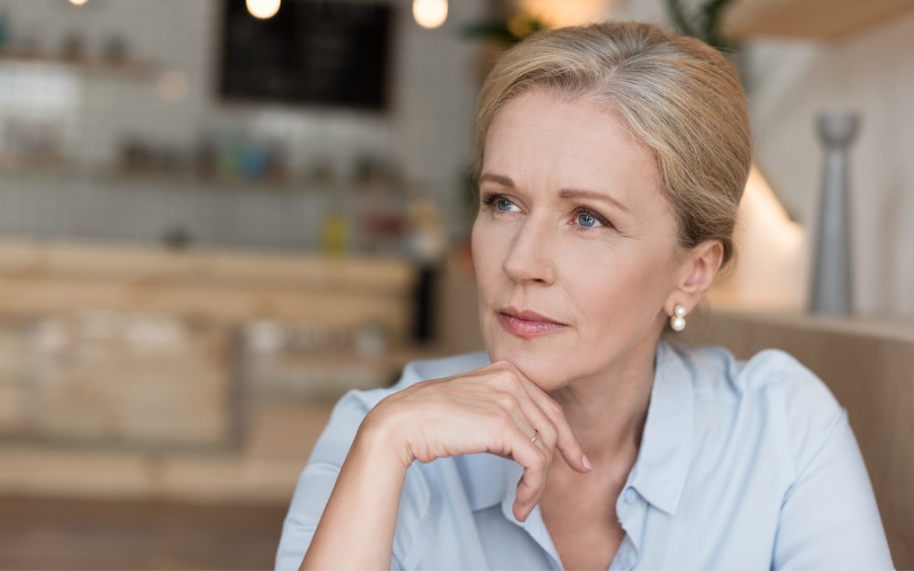 Woman thinking about the importance of Superannuation and Wills, realizing these are essential Components of Australian Estate Planning