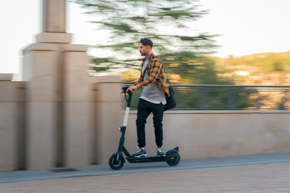 Man riding an e-scooter at high speed