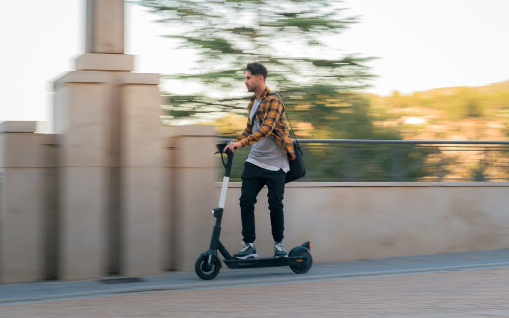 Man riding an e-scooter at high speed