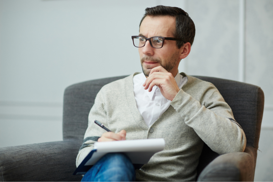 Pensive man making a handwritten Will