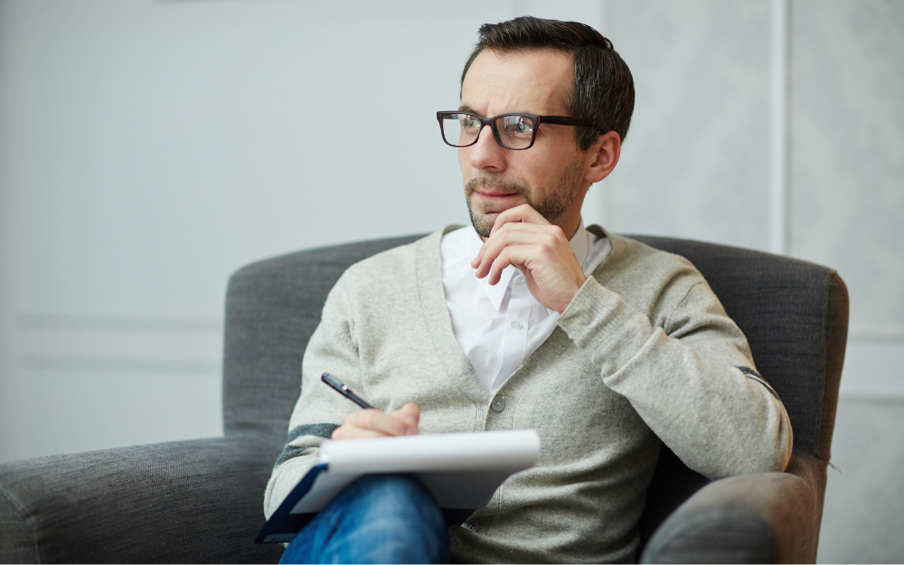 Pensive man making a handwritten Will