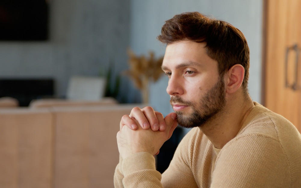 Pensive man thinking about probate caveats: estate dispute