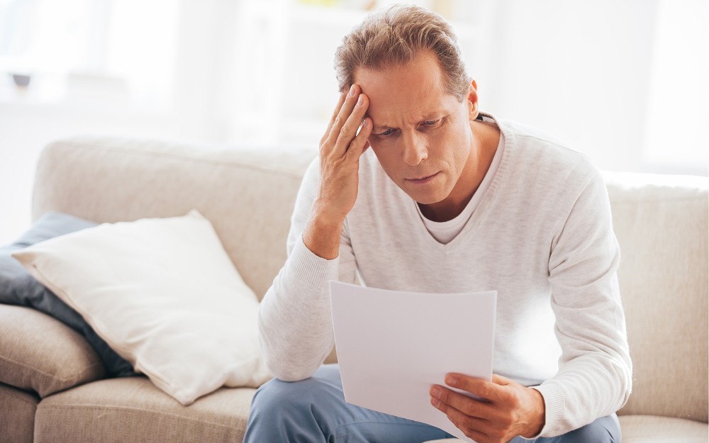 Man reading a letter about his rejected tpd claim