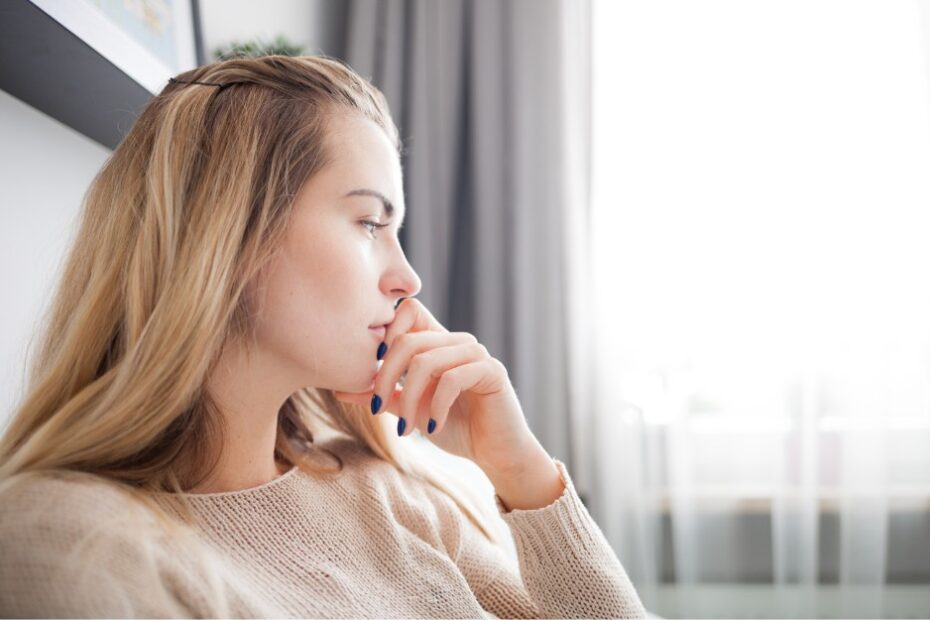 Pensive young woman with condition belonging to top reasons for tpd claims, thinking about how to maximise her payout