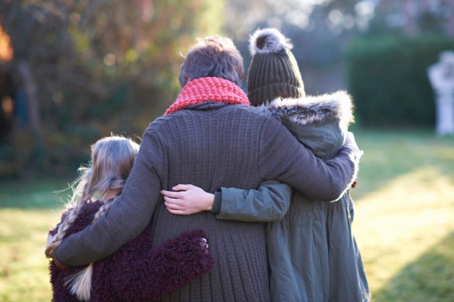 Grieving family in garden, knowing about death benefit claims