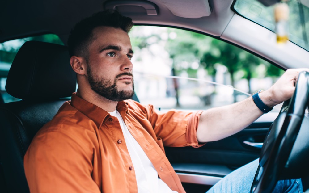 Man driving, not wearing a seatbelt; man driving with no seatbelt