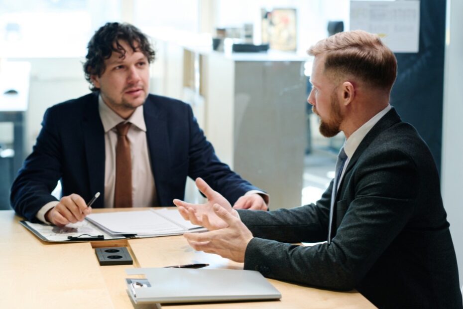 Man talking to a lawyer to avoid common estate planning mistakes