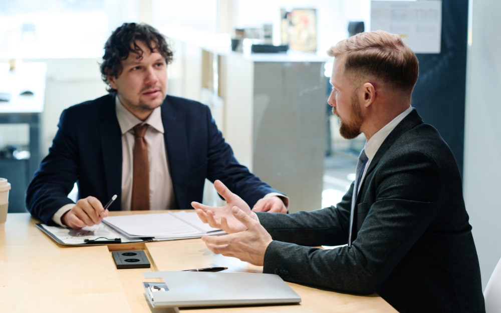 Man talking to a lawyer to avoid common estate planning mistakes