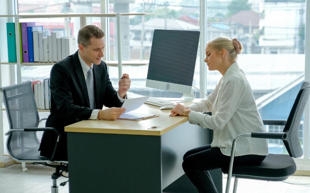 Female employee talking to her employer about her return to work after a workers compensation claim in Queensland